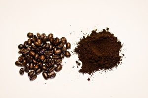 Coffee beans and ground coffee in separate piles.