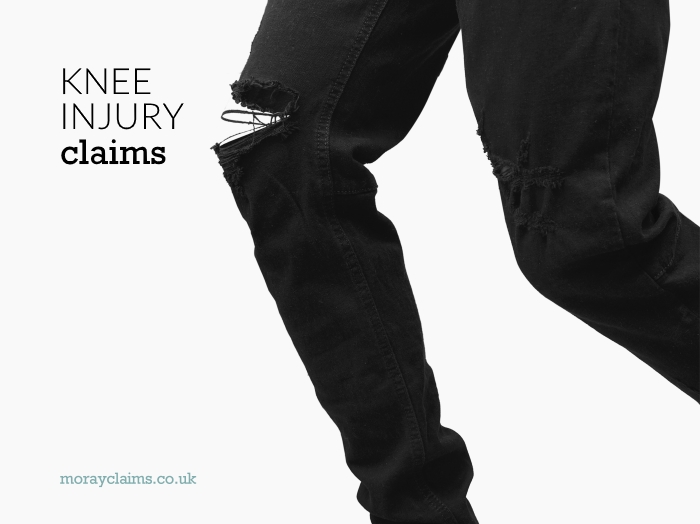 Damaged knee in pair of black jeans